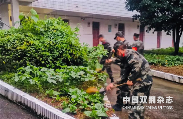 防洪官兵在休息间隙，清理雨后的校园.png