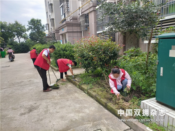 束正国（扫地）与志愿者一起参加青龙华庄小区卫生大扫除。.png